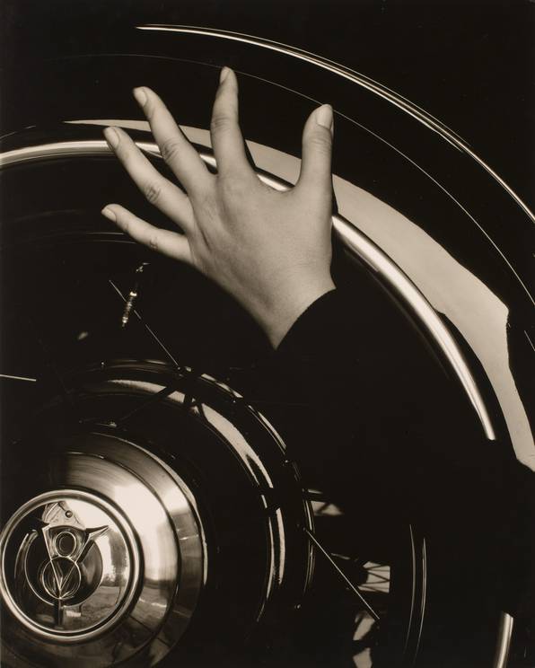 Alfred Stieglitz  - Georgia O’Keeffe, Hand on Back Tire of Ford V8 (1920)